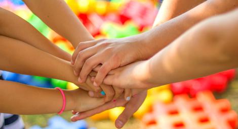 image of a team holding hands