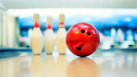 image of a bowling ball and skittles