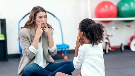 A speech therapist working with a pupil
