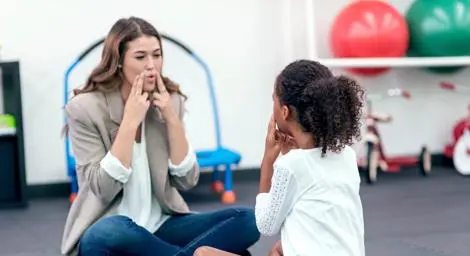 A speech therapist working with a pupil