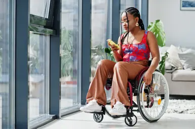 Woman in wheelchair inside house